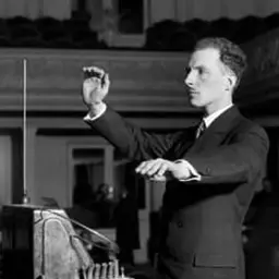Léon Theremin playing the theremin in 1927, hands raised near its antennas